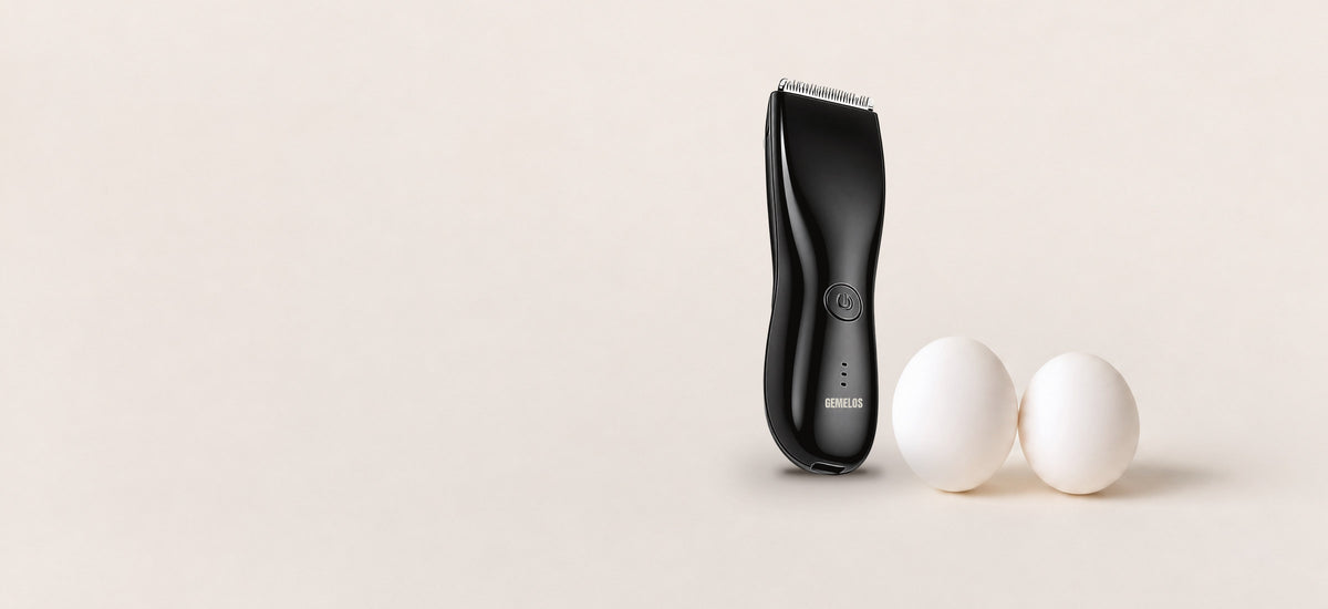 Recortadora íntima negra junto a dos huevos sobre fondo crema, con el logo GEMELOS en el cuerpo
